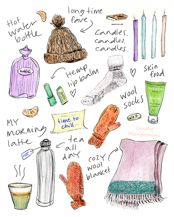 A hand-drawn flat-lay illustration of winter essentials including a Mizu insulated bottle, Weleda Skin Food, The Body Shop hemp lip balm, a wool blanket, knitted hat and  mittens and candles, A cute and cozy winter illustration.